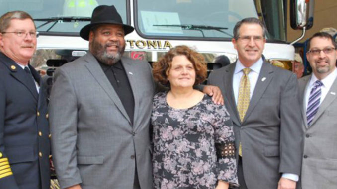 Fire chief, mayor and three city council members in front of new fire truck