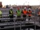 City council members in hard hats touring water plant