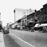 Cars parallel parked along Main Avenue in 1929