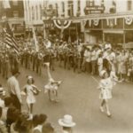 Baton twirlers lead the way in a 1940s parade on Main Avenue