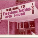 Sign on building says "1955 - Welcome to Firestone Textiles Open House"