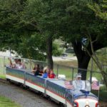 Families wave hello as they ride the Lineberger Park train