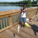 Young boy has caught a fish while fishing at Rankin Lake