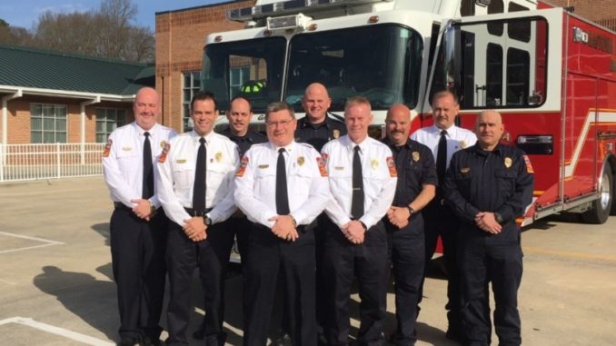 Nine Gastonia firefighters in front of fire truck