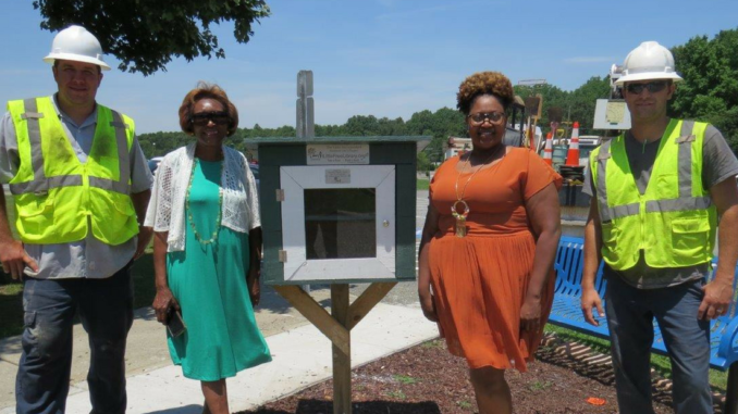 City and school officials alongside Little Free Library