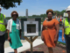 City and school officials alongside Little Free Library
