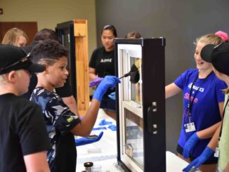 Students dust for fingerprints at CSI camp