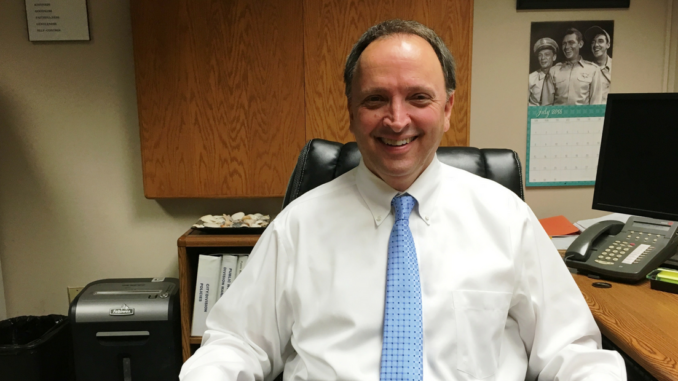 Dale Denton sitting at his desk