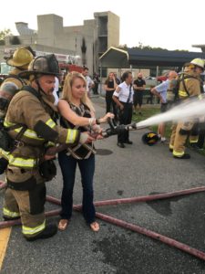 Participant learns how to hold a fire hose