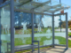 Bus shelter with etched glass showing people jogging, biking and sitting on a park bench