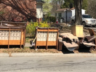 Furniture and trash lined up at street curb
