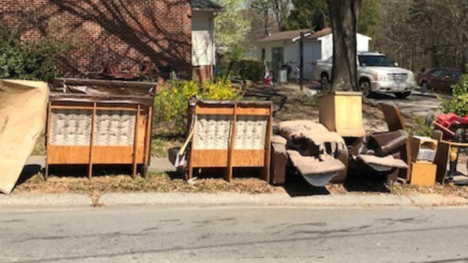 Furniture and trash lined up at street curb