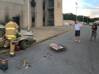 Citizens Academy participants watch fire crews extinguish a car fire