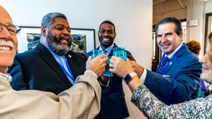 City leaders give a toast with glasses of water