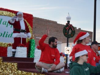 Santa standing on a float in a parade