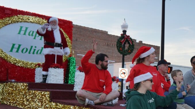 Santa standing on a float in a parade