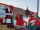 Santa standing on a float in a parade