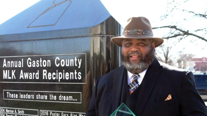 Walker Reid next to MLK monument in Gastonia