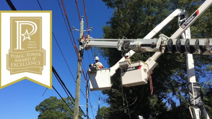 Linemen repairing electric lines, Public Power award logo