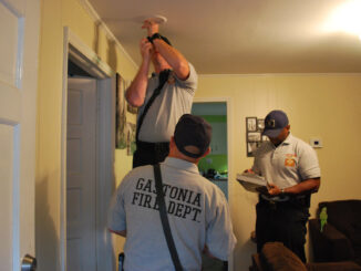 Firefighters installing smoke detector