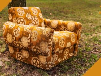 Upholstered chair with bright yellow and brown flowered print fabric