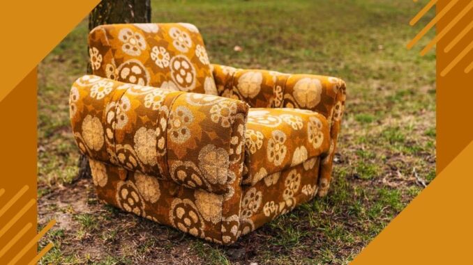 Upholstered chair with bright yellow and brown flowered print fabric