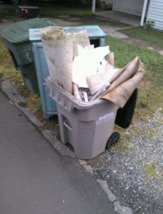 Recycling bin filled with flooring scraps