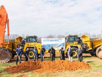 Gastonia City Councilmembers with shovels and dirt in front of heavy equipment