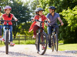 Parents and two children riding bicycles outdoors