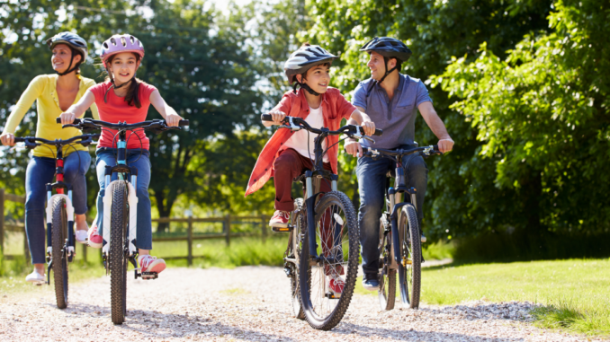 Parents and two children riding bicycles outdoors