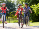 Parents and two children riding bicycles outdoors