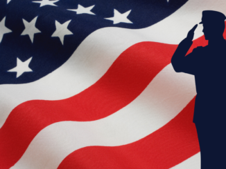 American flag with silhouette of soldier saluting