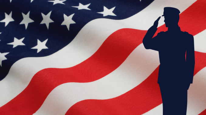 American flag with silhouette of soldier saluting