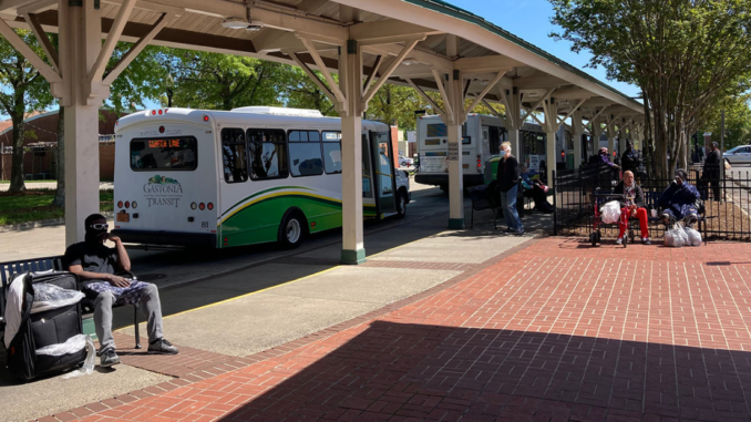 Passengers and buses at Bradley Transit Station
