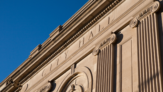 Words City Hall engraved into the stone facade of Gastonia City Halll