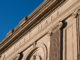 Words City Hall engraved into the stone facade of Gastonia City Halll